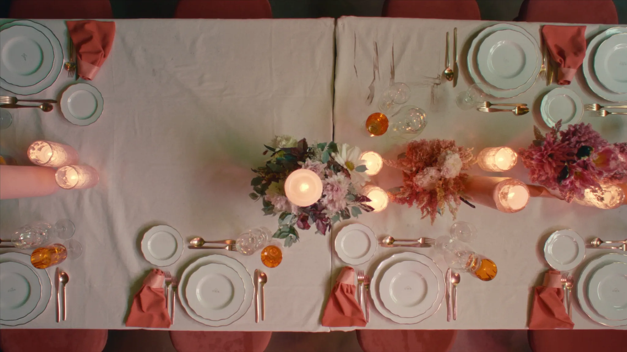 An overhead view of an elegant wedding reception tablescape with florals and candles